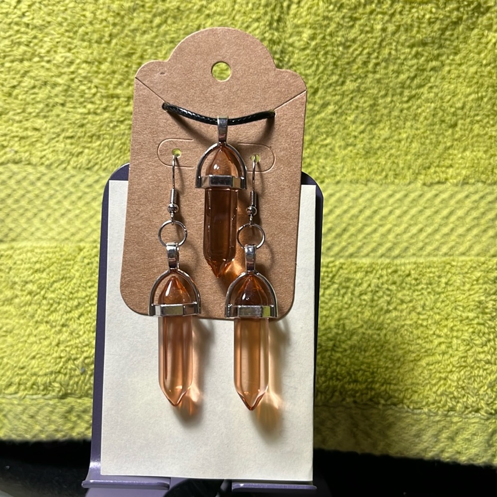 Brown glass pendant necklace and earring set.‎